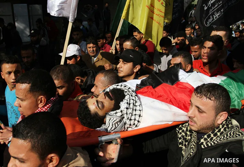 Palestinians carry the body of 29-year-old Ibrahim Abu Thurayeh during his funeral in Gaza City on December 16, 2017 after he was shot dead in clashes between Israeli forces and protesters along the Gaza-Israel border, a...