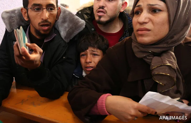 Palestinians wait for travel permits to cross into Egypt through the Rafah border crossing after it was opened by Egyptian authorities for humanitarian cases, in the southern Gaza Strip December 17, 2017. Photo by Ashraf...