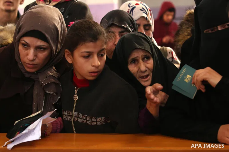 Palestinians wait for travel permits to cross into Egypt through the Rafah border crossing after it was opened by Egyptian authorities for humanitarian cases, in the southern Gaza Strip December 17, 2017. Photo by Ashraf...