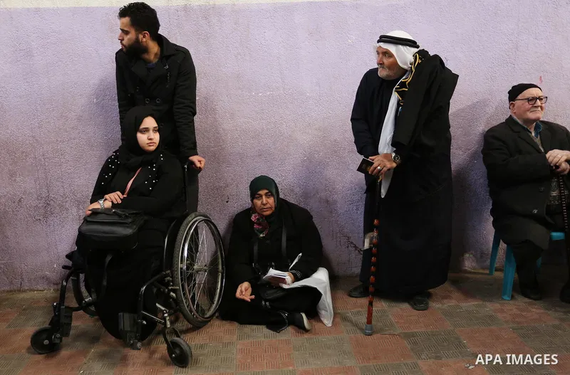 Palestinians wait for travel permits to cross into Egypt through the Rafah border crossing after it was opened by Egyptian authorities for humanitarian cases, in the southern Gaza Strip December 17, 2017. Photo by Ashraf...