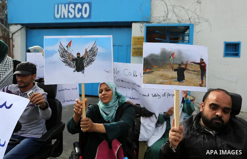 Disabled Palestinians take part in a protest against the killing of Ibraheem Abu Thuraya in front of the headquarter United Nation "UNESCO", in Gaza City, on December 21, 2017. Abu Thuraya, who was shot dead by Israeli s...
