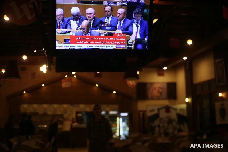 Palestinians watch a televised broadcast of the U.N. General Assembly emergency special session to vote on a draft resolution calling on the United States to withdraw its recognition of Jerusalem as Israel's capital, in...