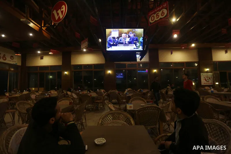 Palestinians watch a televised broadcast of the U.N. General Assembly emergency special session to vote on a draft resolution calling on the United States to withdraw its recognition of Jerusalem as Israel's capital, in...