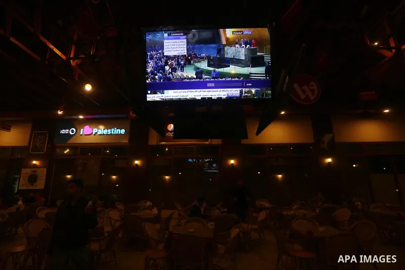 Palestinians watch a televised broadcast of the U.N. General Assembly emergency special session to vote on a draft resolution calling on the United States to withdraw its recognition of Jerusalem as Israel's capital, in...