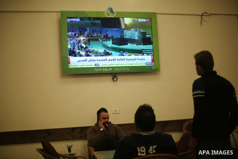 Palestinians watch a televised broadcast of the U.N. General Assembly emergency special session to vote on a draft resolution calling on the United States to withdraw its recognition of Jerusalem as Israel's capital, in...