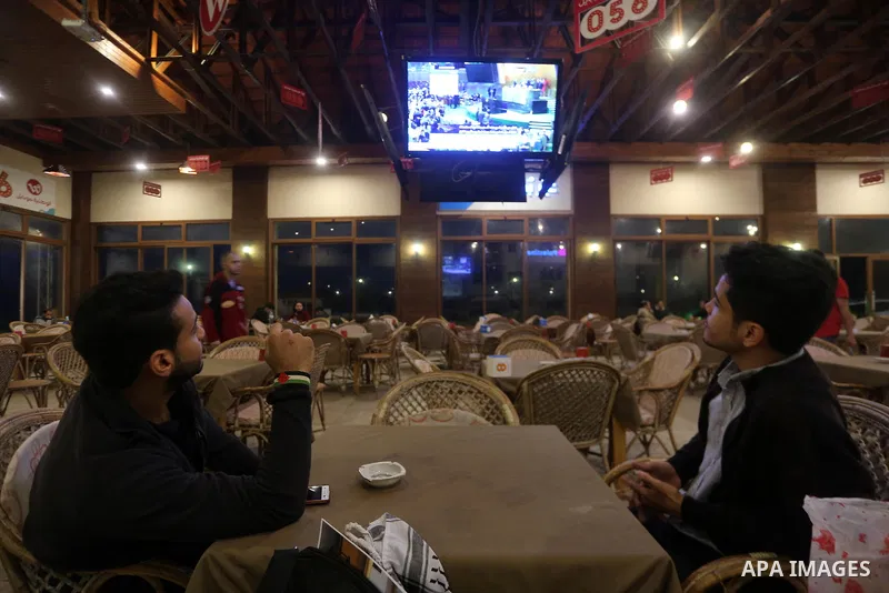Palestinians watch a televised broadcast of the U.N. General Assembly emergency special session to vote on a draft resolution calling on the United States to withdraw its recognition of Jerusalem as Israel's capital, in...