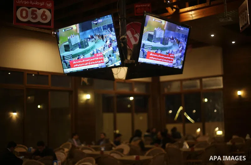 Palestinians watch a televised broadcast of the U.N. General Assembly emergency special session to vote on a draft resolution calling on the United States to withdraw its recognition of Jerusalem as Israel's capital, in...