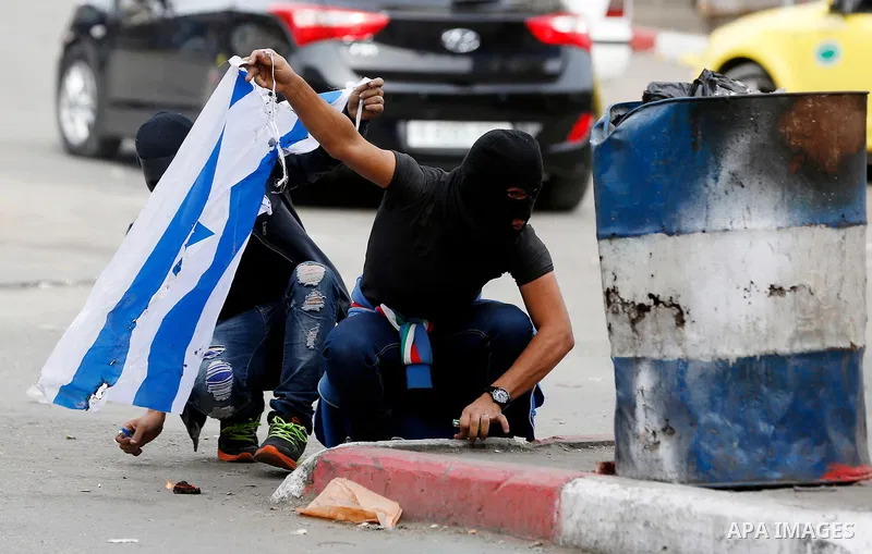 Palestinian protesters clash with Israeli security forces, at a protest as Palestinians call for a "Day of Rage" in response to U.S. President Donald Trump's recognition of Jerusalem as Israel's capital, in the West Bank...