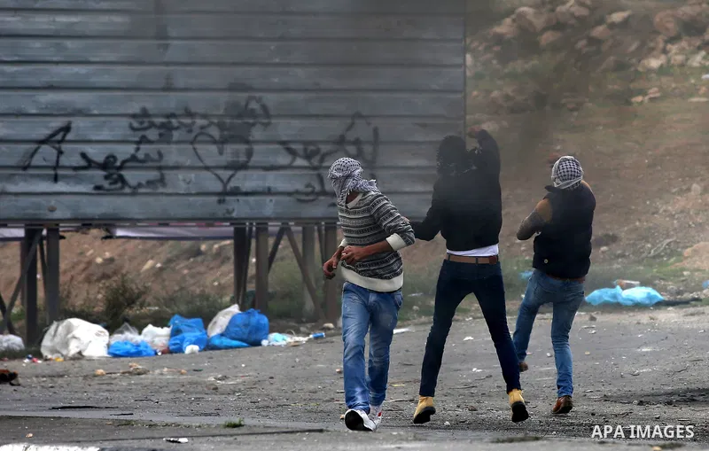 Palestinian protesters clash with Israeli security forces near the Huwara checkpoint south of Nablus in the Israeli-occupied West Bank, as Palestinians call for a "Day of Rage" in response to U.S. President Donald Trump'...