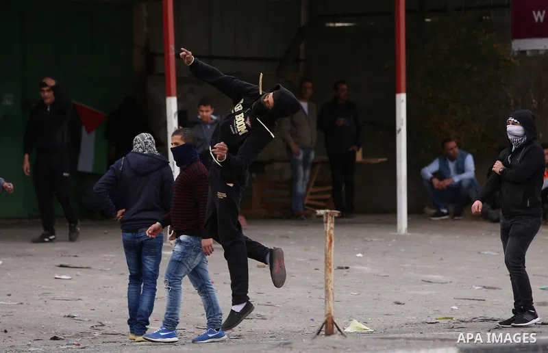 Palestinian protesters clash with Israeli security forces near the Huwara checkpoint south of Nablus in the Israeli-occupied West Bank, as Palestinians call for a "Day of Rage" in response to U.S. President Donald Trump'...