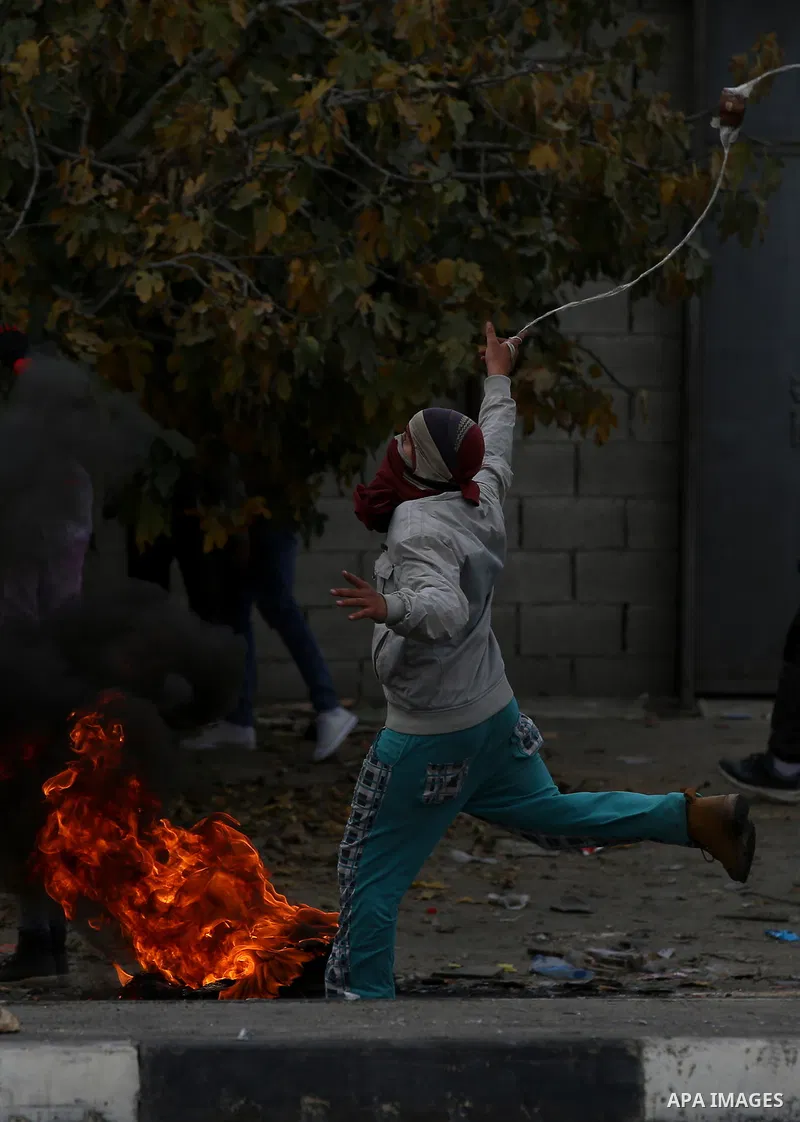 Palestinian protesters clash with Israeli security forces near the Huwara checkpoint south of Nablus in the Israeli-occupied West Bank, as Palestinians call for a "Day of Rage" in response to U.S. President Donald Trump'...