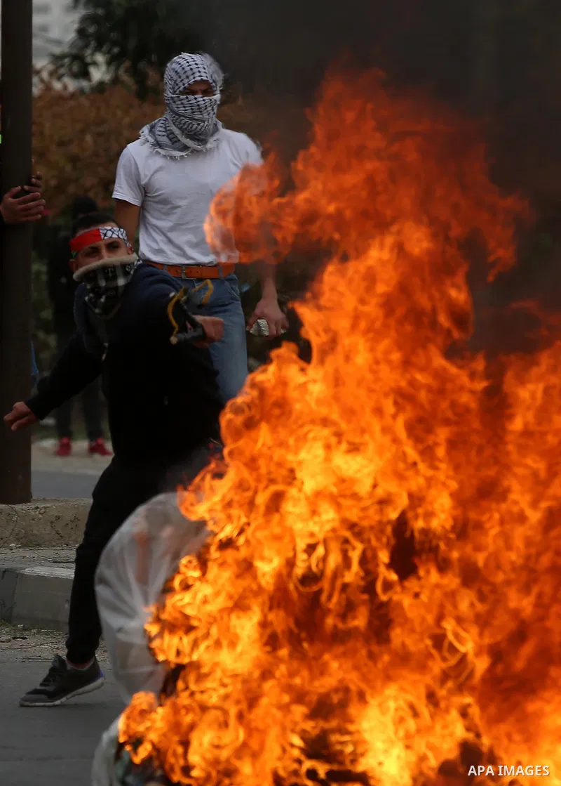 Palestinian protesters clash with Israeli security forces near the Huwara checkpoint south of Nablus in the Israeli-occupied West Bank, as Palestinians call for a "Day of Rage" in response to U.S. President Donald Trump'...