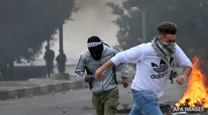 Palestinian protesters clash with Israeli security forces near the Huwara checkpoint south of Nablus in the Israeli-occupied West Bank, as Palestinians call for a "Day of Rage" in response to U.S. President Donald Trump'...
