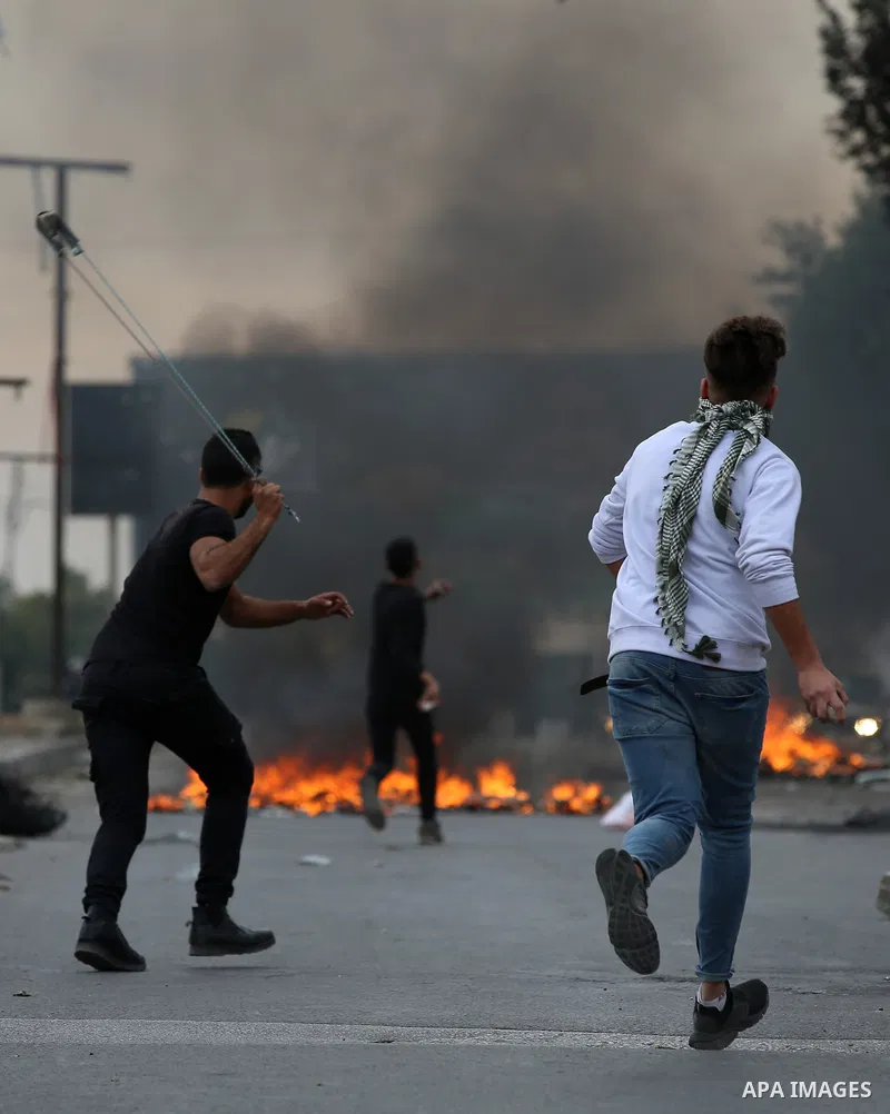 Palestinian protesters clash with Israeli security forces near the Huwara checkpoint south of Nablus in the Israeli-occupied West Bank, as Palestinians call for a "Day of Rage" in response to U.S. President Donald Trump'...