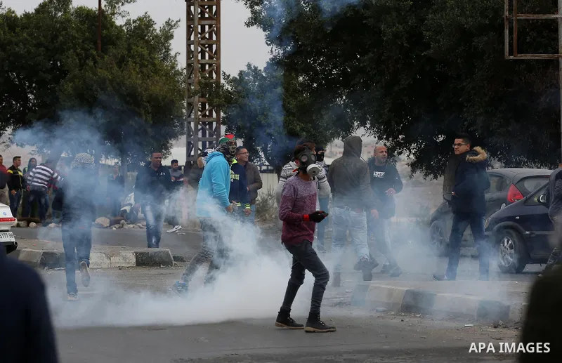 Palestinian protesters clash with Israeli security forces near the Huwara checkpoint south of Nablus in the Israeli-occupied West Bank, as Palestinians call for a "Day of Rage" in response to U.S. President Donald Trump'...