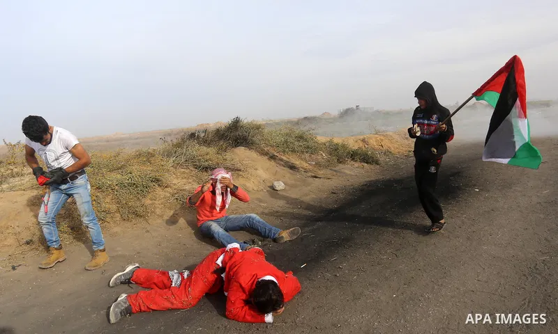 A wounded Palestinian protester dressed as Santa Claus lies on the ground during clashes with Israeli security forces, at a protest as Palestinians call for a "Day of Rage" in response to U.S. President Donald Trump's re...