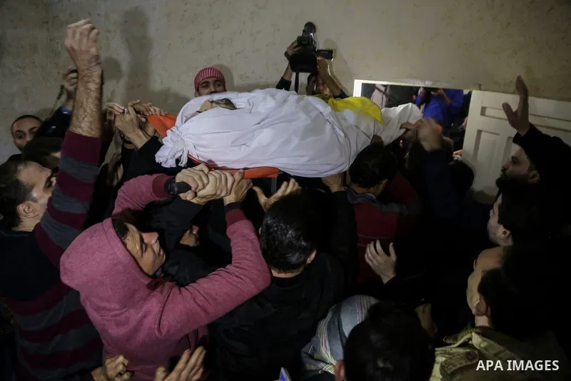 Palestinian mourners carry the body of Mohamed Moheisen, 29, who was killed during clashes with Israeli troops, during his funeral in Gaza city on December 23, 2017. Two Palestinians were killed as youths clashed with Is...
