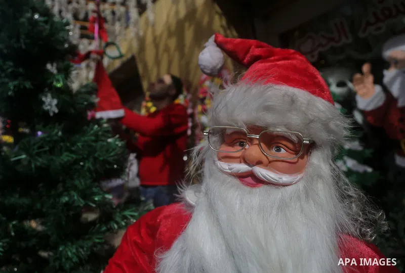 A Palestinian vendor displays decorations of New Year 2018, at his shop in Gaza city on December 25, 2017. Photo by Mohammed Dahman