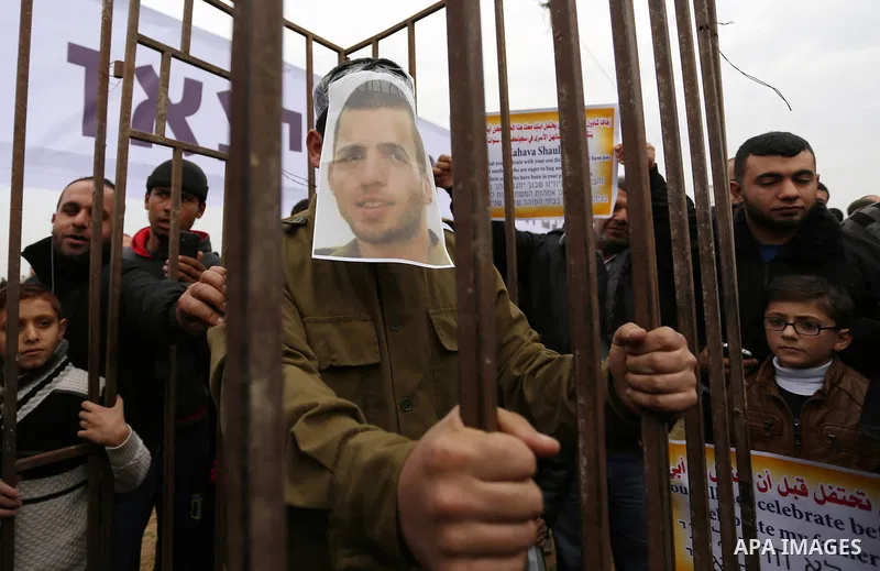 A Palestinian man playing the role of Israeli soldier Oron Shaul stands in a mock jail during a rally in solidarity with Palestinian prisoners held in Israeli jails, in the northern Gaza Strip December 29, 2017. Photo by...