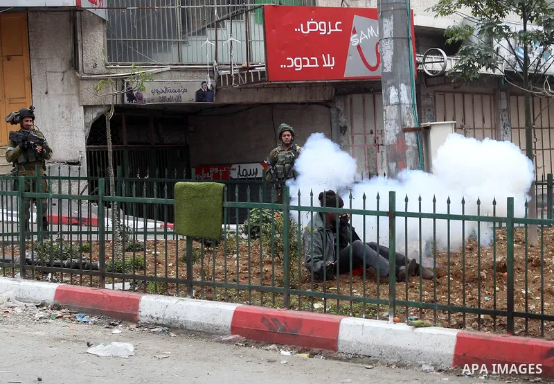 Israeli security forces take position during clashes with Palestinian protesters in the occupied West Bank city of Hebron on December 29, 2017 as protests continue over US President Donald Trump's declaration of Jerusale...