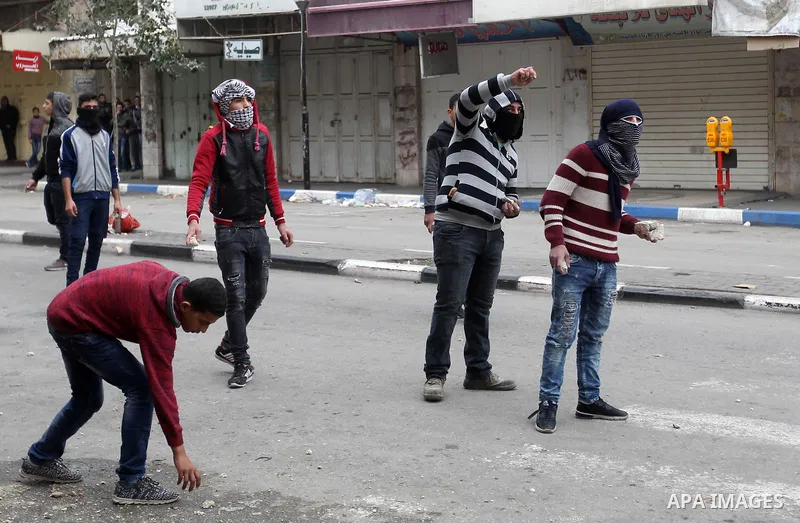 Palestinian demonstrators clash with Israeli security forces in the occupied West Bank city of Hebron on December 29, 2017 as protests continue over US President Donald Trump's declaration of Jerusalem as Israel's capita...