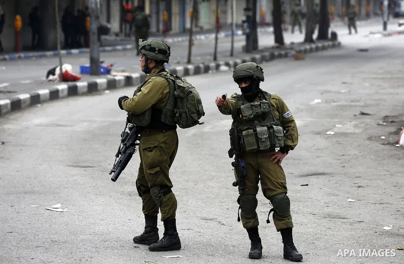 Israeli security forces take position during clashes with Palestinian protesters in the occupied West Bank city of Hebron on December 29, 2017 as protests continue over US President Donald Trump's declaration of Jerusale...
