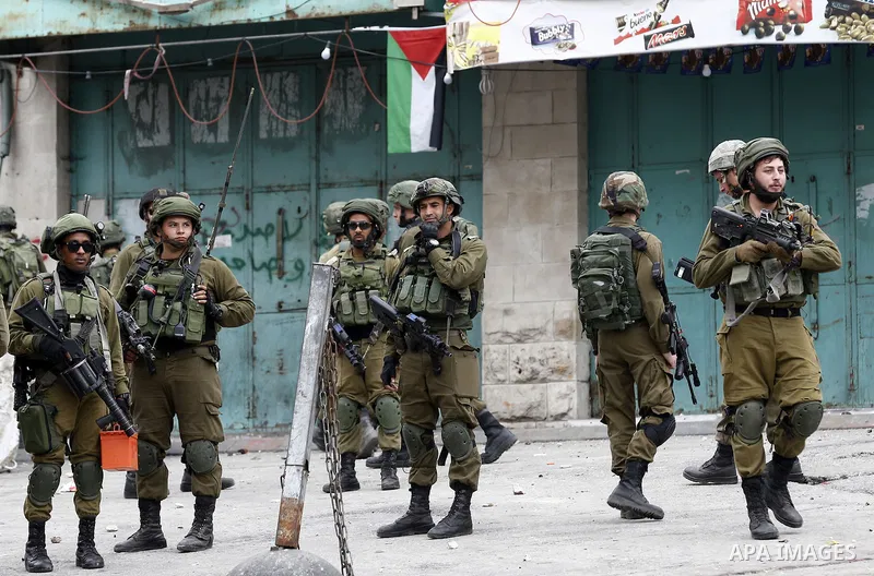 Israeli security forces take position during clashes with Palestinian protesters in the occupied West Bank city of Hebron on December 29, 2017 as protests continue over US President Donald Trump's declaration of Jerusale...