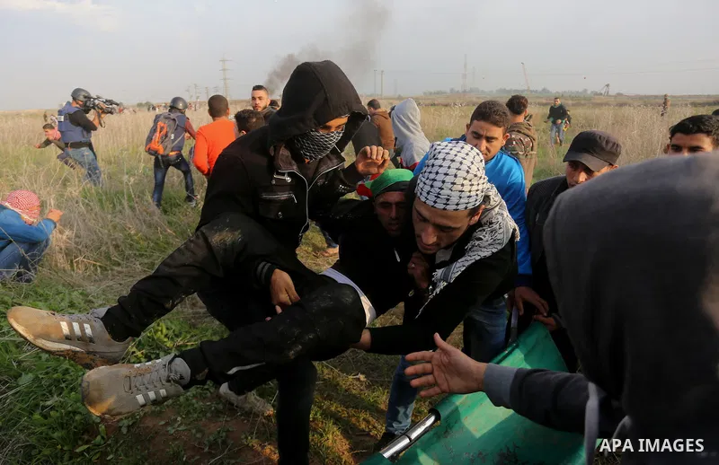 A wounded Palestinian demonstrator is evacuated during clashes with Israeli security forces near the Israel-Gaza border east of Gaza City on December 29, 2017, as demonstrations continue over the US president's controver...