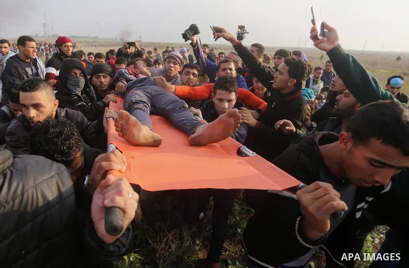 A wounded Palestinian demonstrator is evacuated during clashes with Israeli security forces near the Israel-Gaza border east of Gaza City on December 29, 2017, as demonstrations continue over the US president's controver...