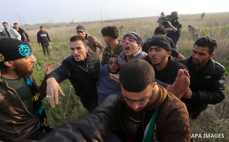 A wounded Palestinian demonstrator is evacuated during clashes with Israeli security forces near the Israel-Gaza border east of Gaza City on December 29, 2017, as demonstrations continue over the US president's controver...