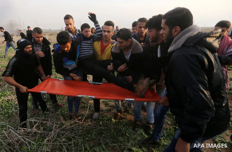 A wounded Palestinian demonstrator is evacuated during clashes with Israeli security forces near the Israel-Gaza border east of Gaza City on December 29, 2017, as demonstrations continue over the US president's controver...