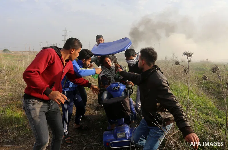 A wounded Palestinian demonstrator is evacuated during clashes with Israeli security forces near the Israel-Gaza border east of Gaza City on December 29, 2017, as demonstrations continue over the US president's controver...