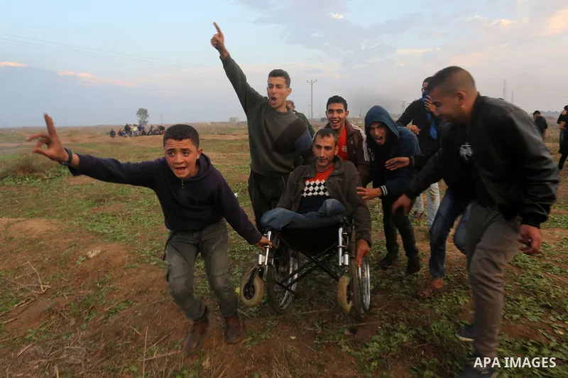 A wounded Palestinian demonstrator is evacuated during clashes with Israeli security forces near the Israel-Gaza border east of Gaza City on December 29, 2017, as demonstrations continue over the US president's controver...