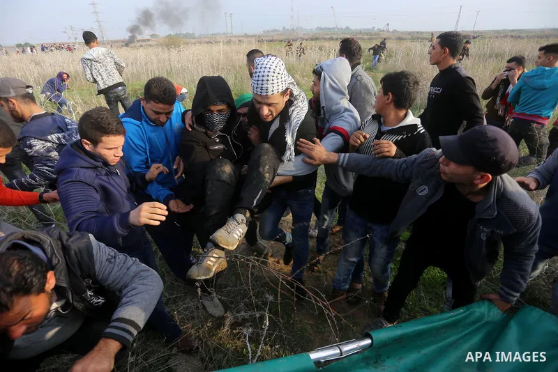 A wounded Palestinian demonstrator is evacuated during clashes with Israeli security forces near the Israel-Gaza border east of Gaza City on December 29, 2017, as demonstrations continue over the US president's controver...