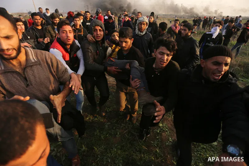 A wounded Palestinian demonstrator is evacuated during clashes with Israeli security forces near the Israel-Gaza border east of Gaza City on December 29, 2017, as demonstrations continue over the US president's controver...