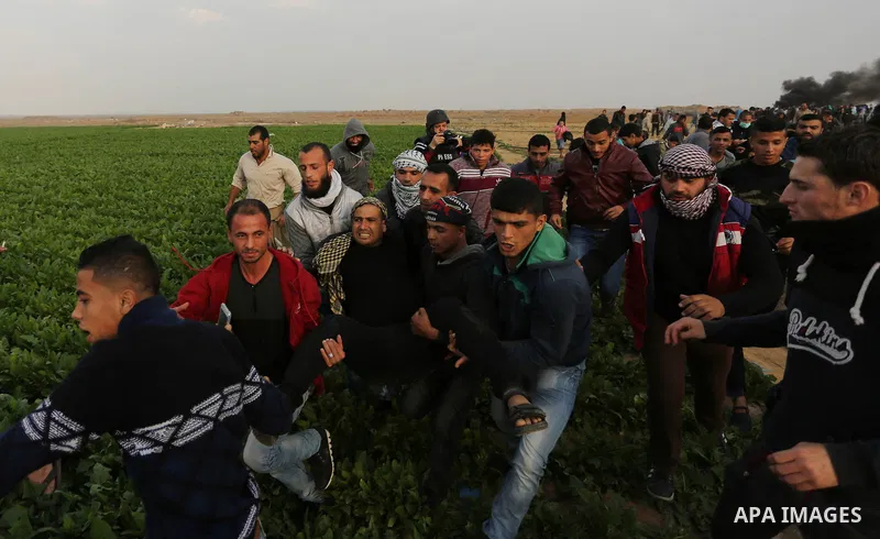 A wounded Palestinian protester is evacuated during clashes with Israeli security forces near the border with Israel in the southern Gaza Strip on December 29, 2017, as demonstrations continue over the US president's con...