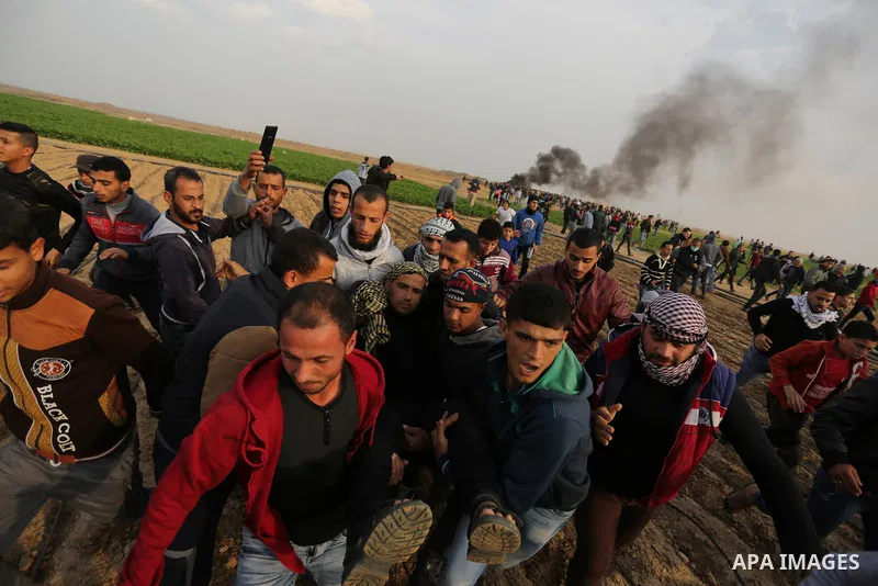 A wounded Palestinian protester is evacuated during clashes with Israeli security forces near the border with Israel in the southern Gaza Strip on December 29, 2017, as demonstrations continue over the US president's con...