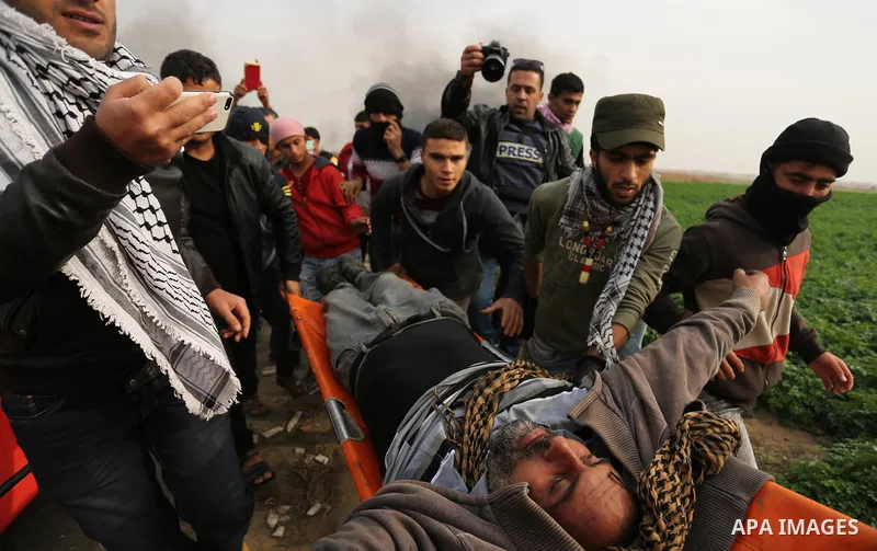 A wounded Palestinian protester is evacuated during clashes with Israeli security forces near the border with Israel in the southern Gaza Strip on December 29, 2017, as demonstrations continue over the US president's con...