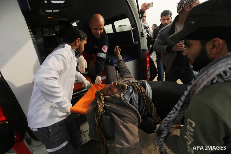 A wounded Palestinian protester is evacuated during clashes with Israeli security forces near the border with Israel in the southern Gaza Strip on December 29, 2017, as demonstrations continue over the US president's con...