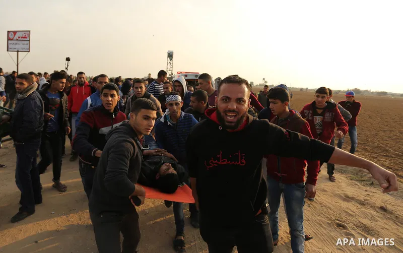 A wounded Palestinian protester is evacuated during clashes with Israeli security forces near the border with Israel in the southern Gaza Strip on December 29, 2017, as demonstrations continue over the US president's con...