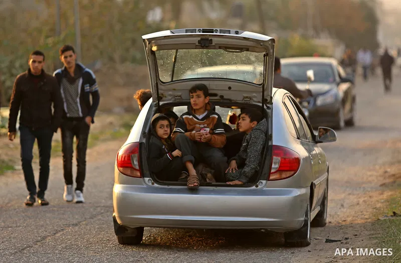 Palestinian children site in a car in the southern Gaza Strip on December 29, 2017. Photo by Ashraf Amra