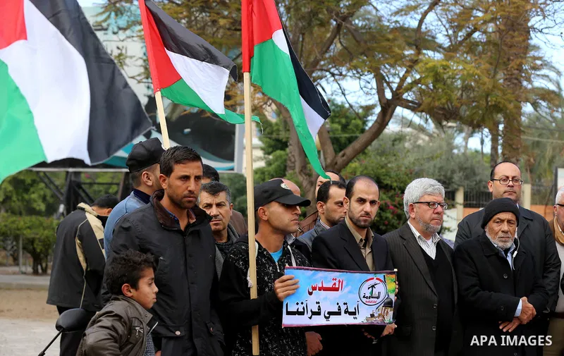 Palestinians attend hold banners during a protest against U.S. President Donald Trump's decision to recognise Jerusalem as the capital of Israel, in Gaza City December 31, 2017. Photo by Yasser Qudih