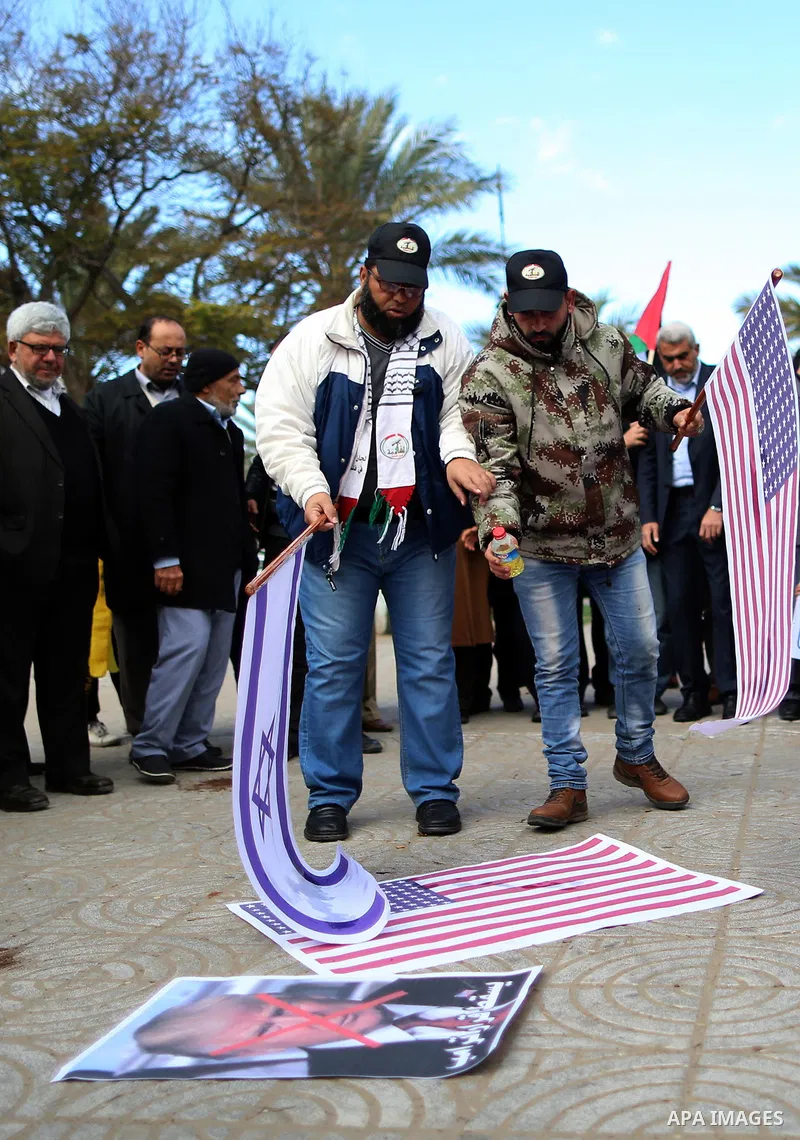 Palestinians attend burn an Israeli flag and a U.S. flag during a protest against U.S. President Donald Trump's decision to recognise Jerusalem as the capital of Israel, in Gaza City December 31, 2017. Photo by Yasser Qu...