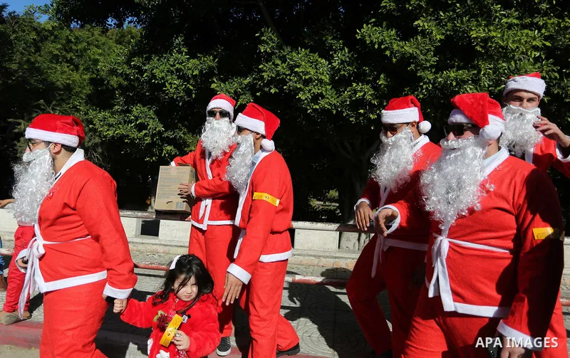 Palestinians dressed as Santa Claus celebrate to welcome the new year, in the streets of Gaza City, New Year's Eve revellers on December 31, 2017. Photo by Ashraf Amra