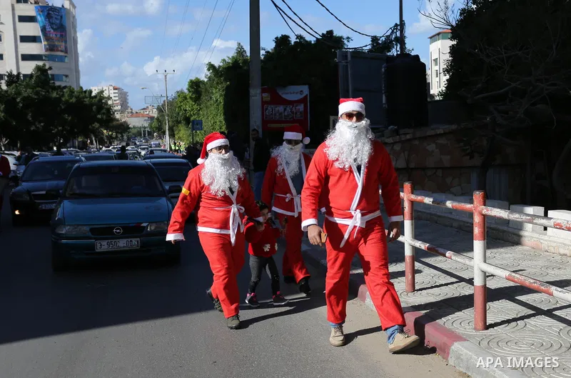 Palestinians dressed as Santa Claus celebrate to welcome the new year, in the streets of Gaza City, New Year's Eve revellers on December 31, 2017. Photo by Ashraf Amra