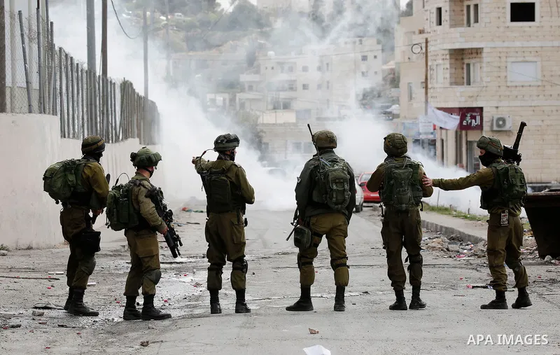 Israeli security forces take postion during clashes with Palestinian protestors in Al-Fawwar refugee camp, south of the West Bank city of Hebron 31 December 2017. Palestinians protest against U.S. President Donald Trump'...