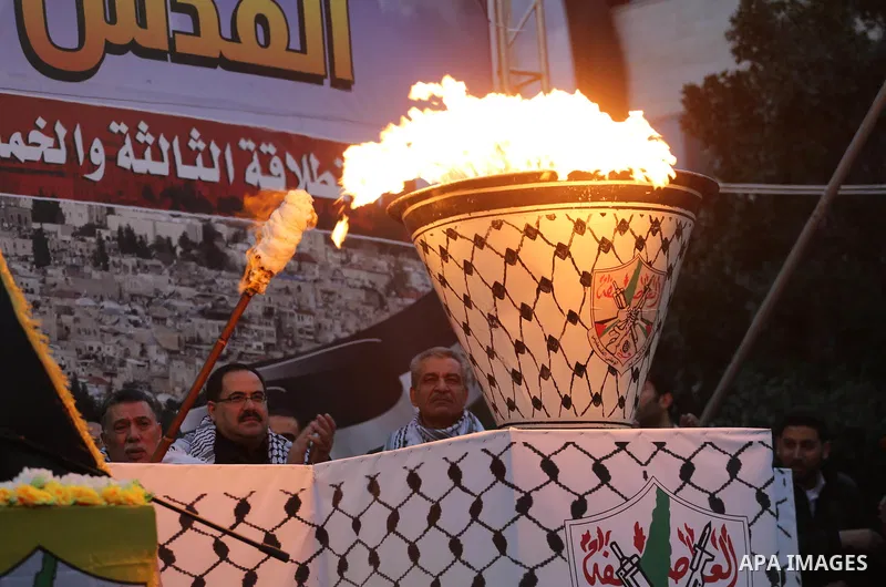 Palestinian supporters of the Fatah movement take part during a rally in Gaza City on December 31, 2017, marking the 53rd anniversary of the creation of the political party. Photo by Mohammed Asad