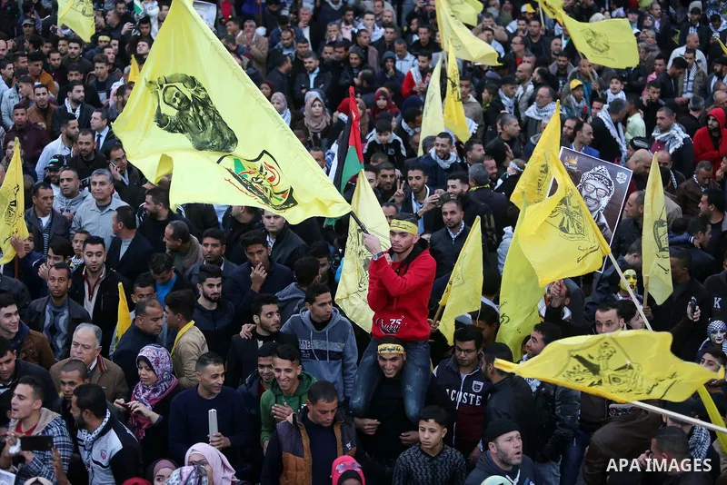 Palestinian supporters of the Fatah movement take part during a rally in Gaza City on December 31, 2017, marking the 53rd anniversary of the creation of the political party. Photo by Ashraf Amra
