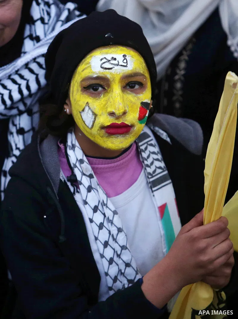 Palestinian supporters of the Fatah movement take part during a rally in Gaza City on December 31, 2017, marking the 53rd anniversary of the creation of the political party. Photo by Ashraf Amra