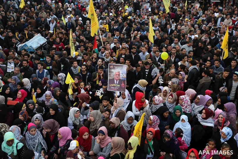Palestinian supporters of the Fatah movement take part during a rally in Gaza City on December 31, 2017, marking the 53rd anniversary of the creation of the political party. Photo by Ashraf Amra